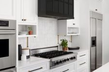 a white farmhouse kitchen with a black kitchen island and an oversized black hood with storage that echoes with the island