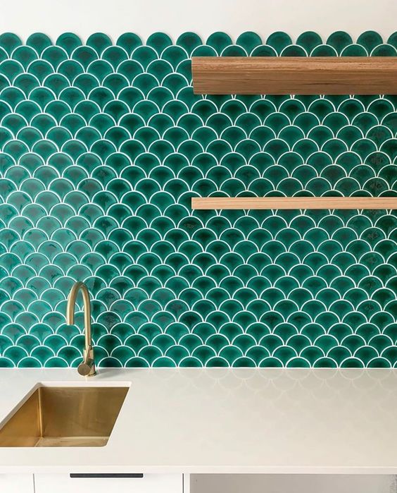 a white kitchen with a bold emerald scallop tile backsplash, open stained shelves and gold touches is fantastic