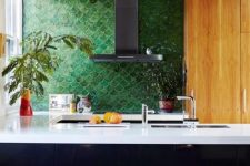 add a colorful accent to your moody monochromatic kitchen with a green fishscale tile backsplash