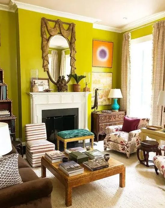 an eclectic chartreuse living room with a fireplace, a couple of sofas, a coffee table and stools and some decor