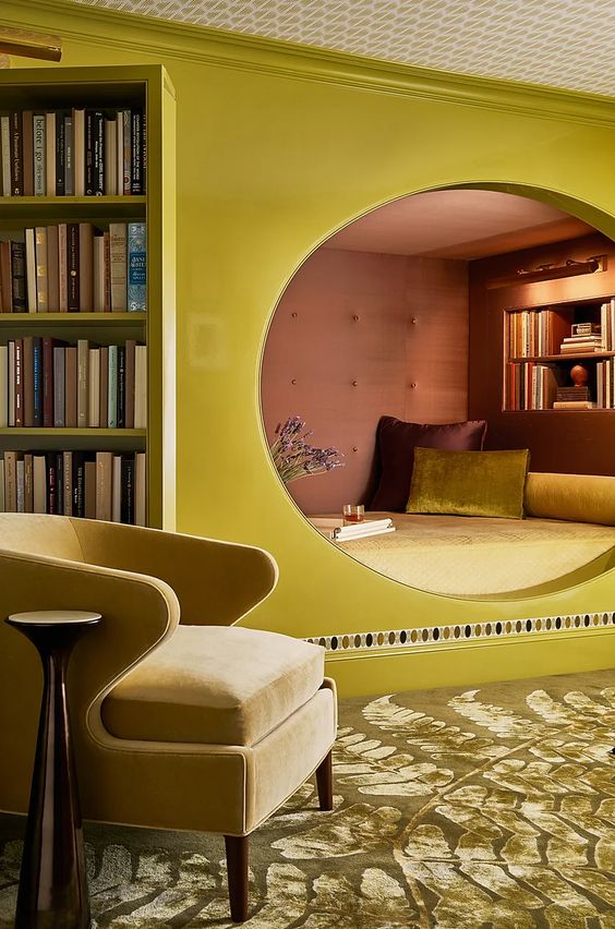 An elegant and whimsical space with a hidden chartreuse room with a bed and built in shelves and a yellow chair