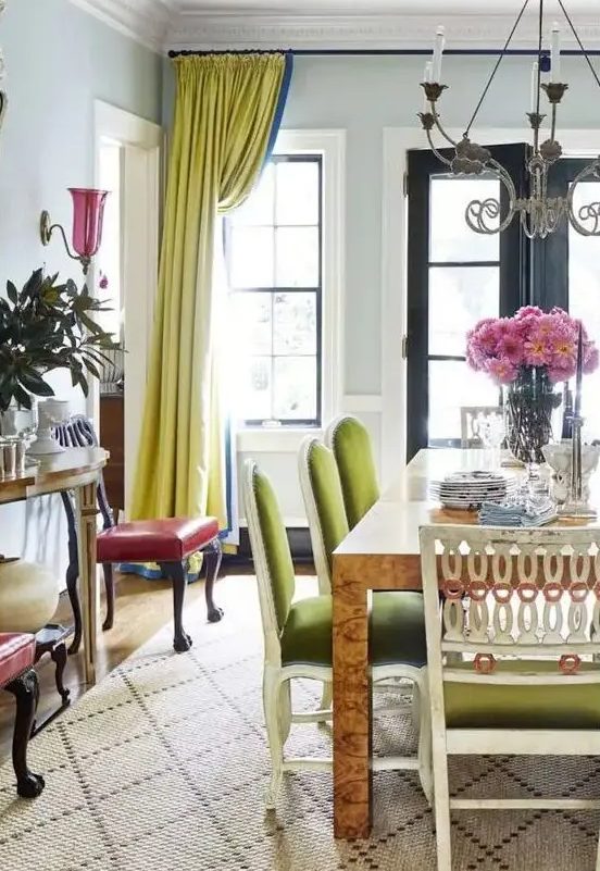 an exquisite dining room with a table, green chairs, chartreuse curtains, a printed rug, red chairs and some plants