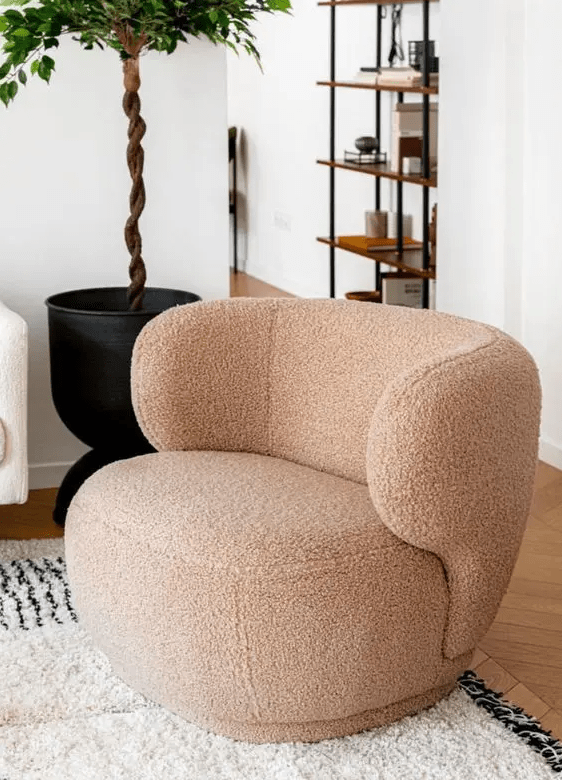 a beige boucle chair with a 70s design is a super chic and trendy furniture piece for your home