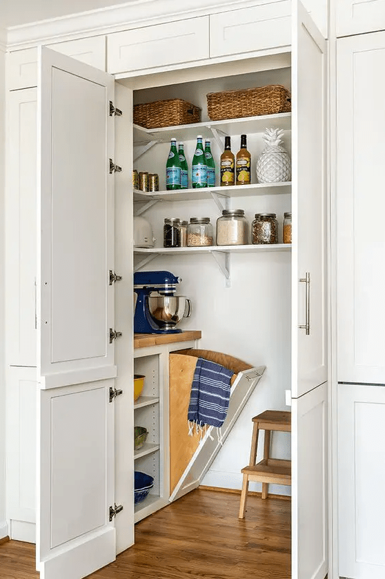 a cool small pantry with corner shelves, a built in open storage unit, a stool and some cookware and appliances