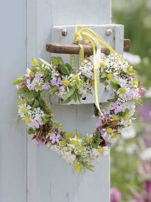 a cute heart-shaped spring wreath with lilac and white wildflowers, greenery and checked ribbon is wow
