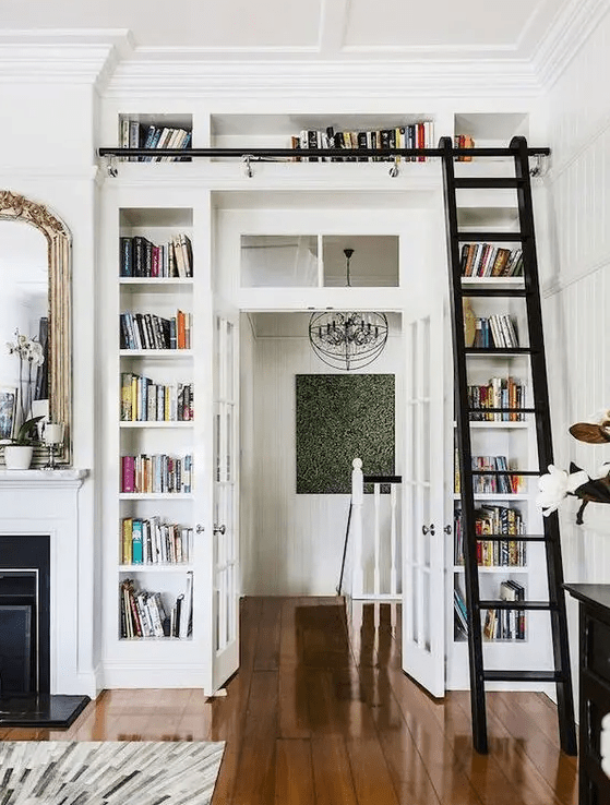 a doorway surrounded with open storage compartments that are used for book storage is a great idea for saving space