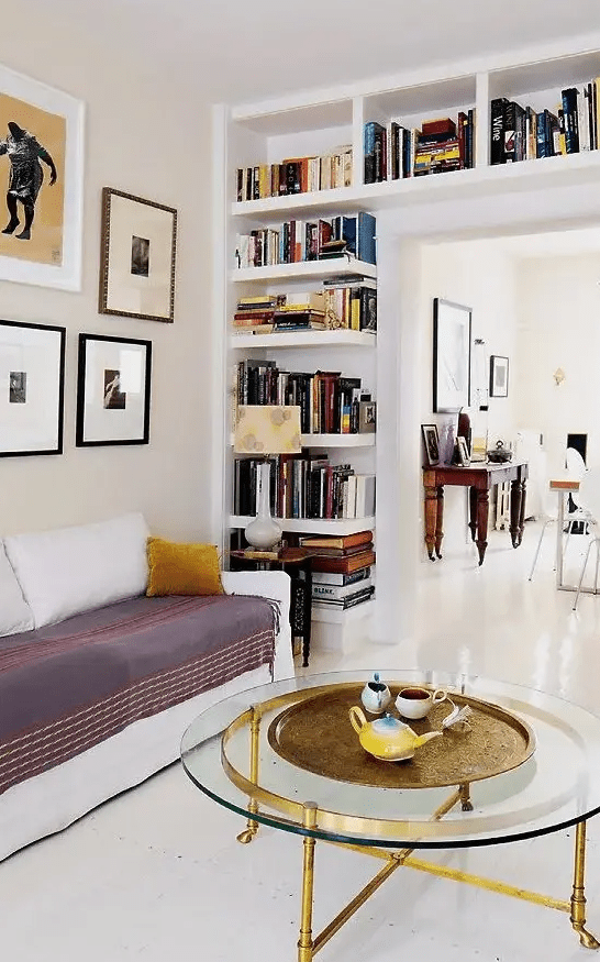 a doorway wall with niche and open shelves is a cool way to store books and to separate the dining and living room more vividly