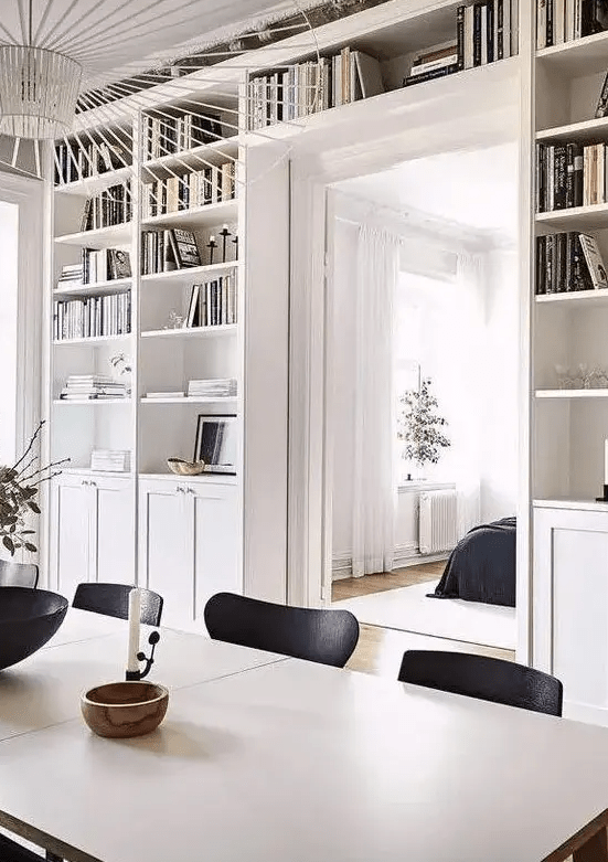 a doorway with open shelves and cabinets surrounding it is a cool idea to store a lot of things without buying separate storage units here and there