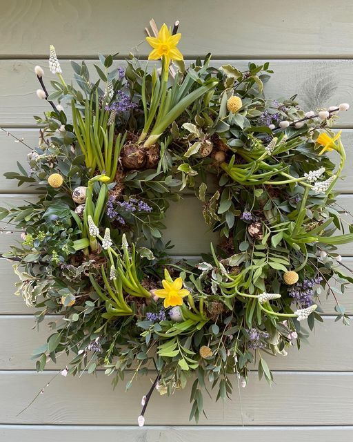 a fab lush and textural spring wreath with greenery, spring bulbs, various twigs and branches