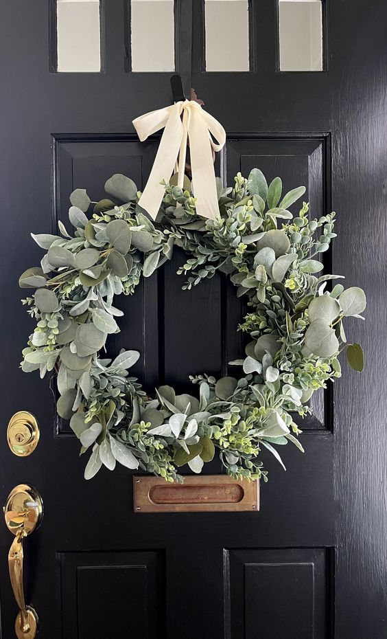 a lovely greenery wreath with a white bow is a timeless idea for spring, and various textures make it cooler