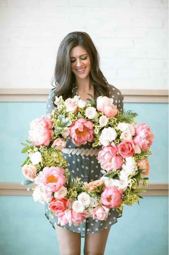 a lush artificial pink flower wreath with some white blooms and greenery is a great idea for spring and it will last long
