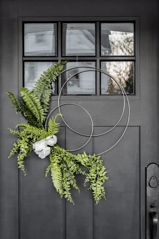 a modern and creative hoop spring wreath with ferns and some artificial blooms is very fresh and cool idea