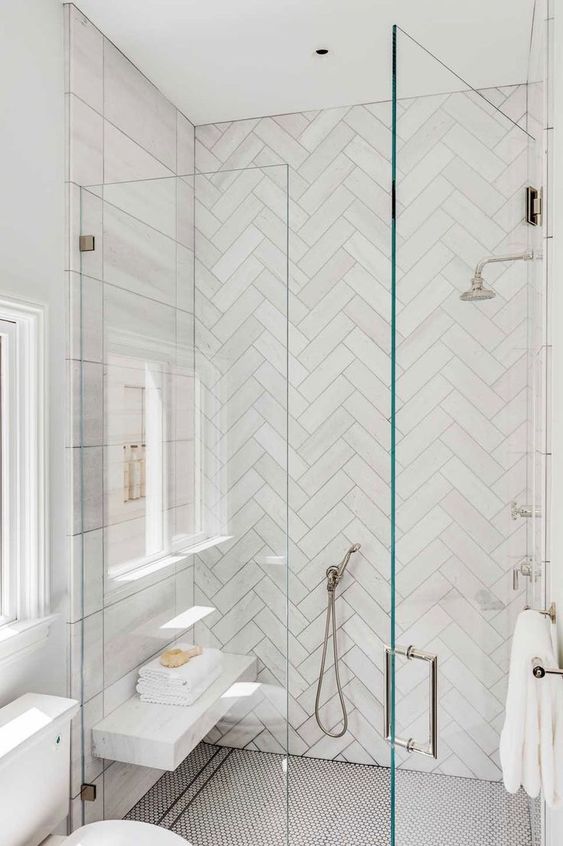 a neutral bathroom with planked walls and herringbone tiles, penny tiles on the floor is a lovely and catchy space