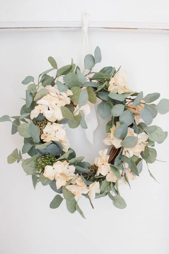 a simple and classy spring wreath with greenery and blush blooms is always a good idea that matches many styles