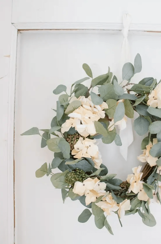 a simple and fresh spring wreath of vine, foliage and neutral blooms is a beautiful and cool decoration to make