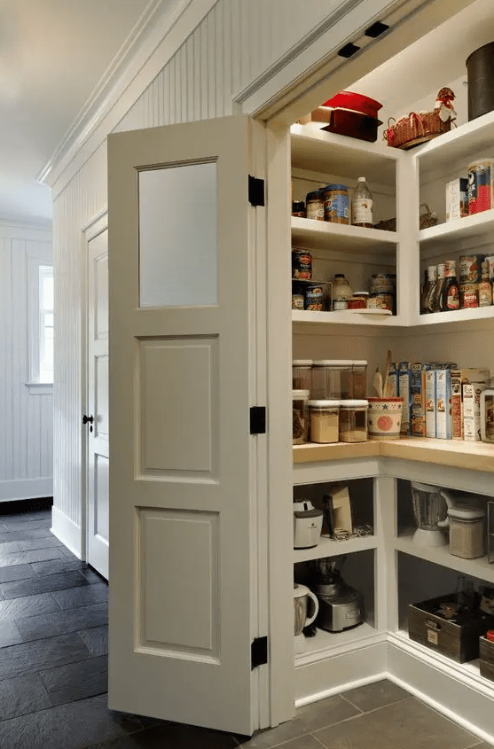 a small and cool pantry with built in storage units and shelves, cookware, appliances, food and drinks and lots of light