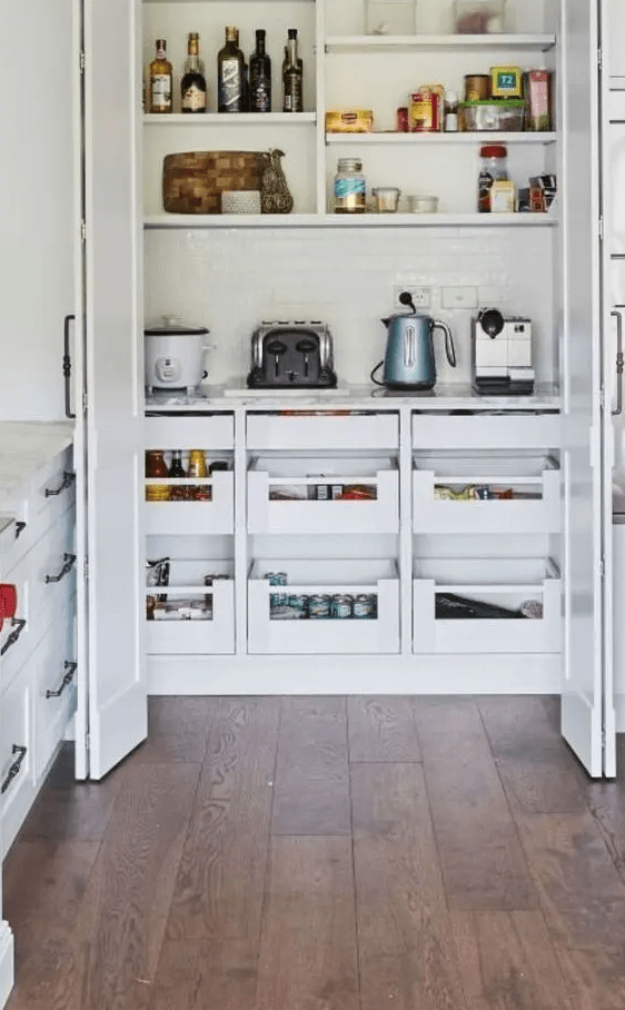 a small built-in pantry with open shelves, drawers, some appliances and food will keep the kitchen clean and decluttered