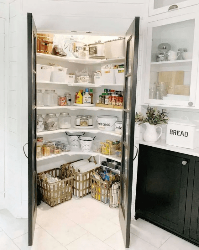 a small corner pantry with corner shelves, baskets and lights plus glass doors to make it more light filled is cool and chic
