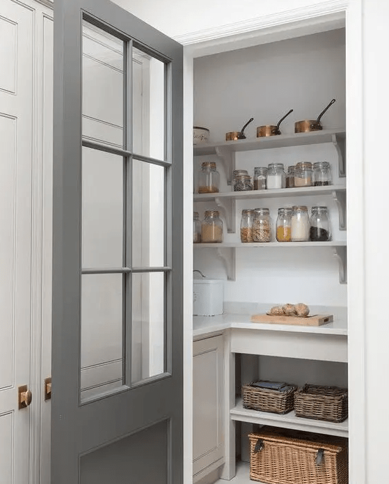 a small pantry with open shelves, built in storage units, baskets, various food and cookware is a cool solution