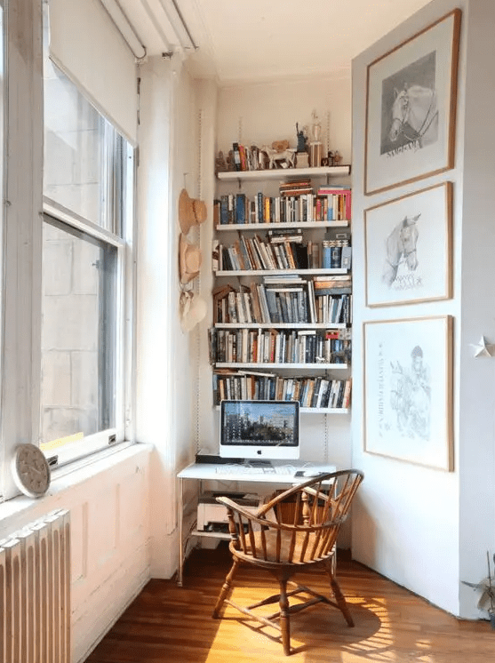 a small working nook with built-in bookshelves, a small desk and a vintage chair is a stylish eclectic space