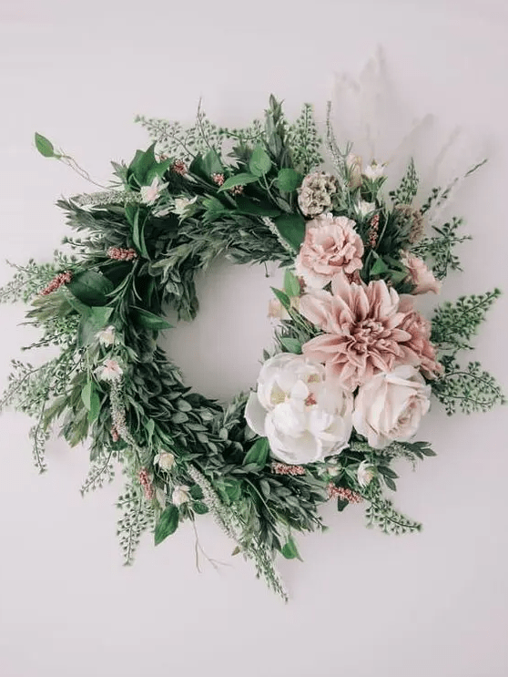 a stylish spring wreath of lots of textural greenery, white and pink blooms is a very fresh idea