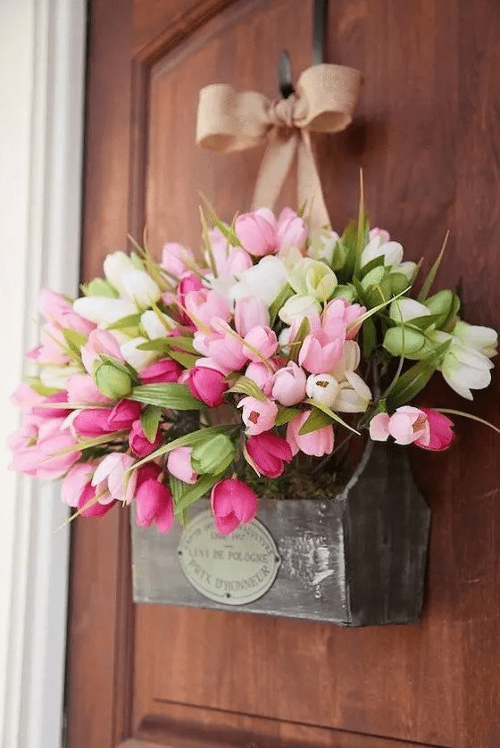 a substitute to a spring door wreath – a box with moss, pink and white tulips and a burlap bow looks creative and feels rustic