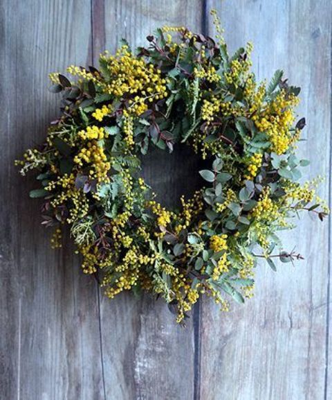 a textured spring wreath with greenery and leaves, mimosa looks very cool and fresh and a bit woodland-like
