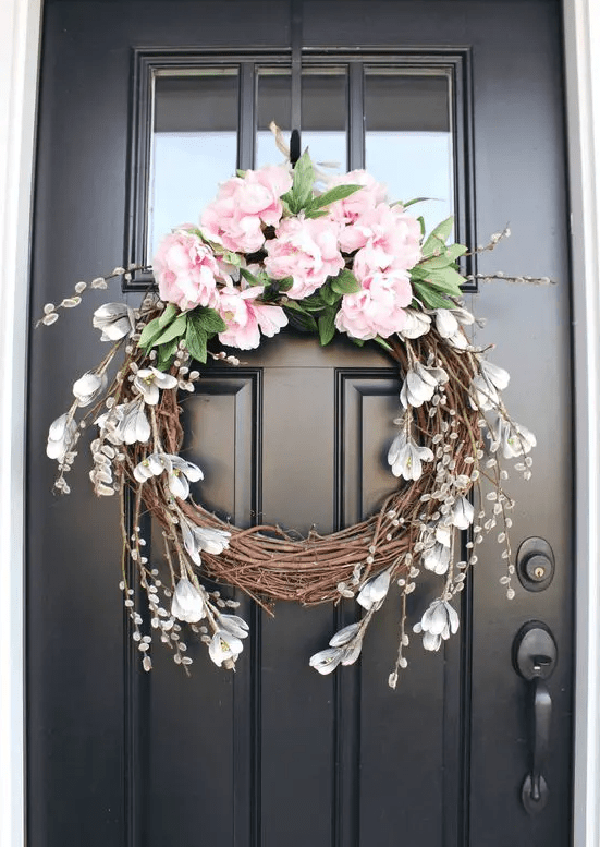 a vine wreath with pink peonies, faux greenery, some faux snowdrops is a pretty idea for a rustic space
