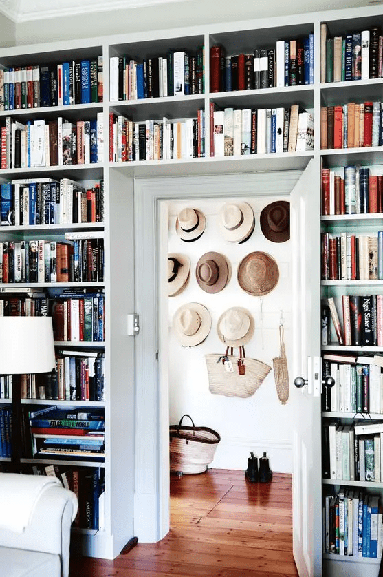 a whole wall taken by bookcases including the space over the door is a smart solution if you have a lot of books at home