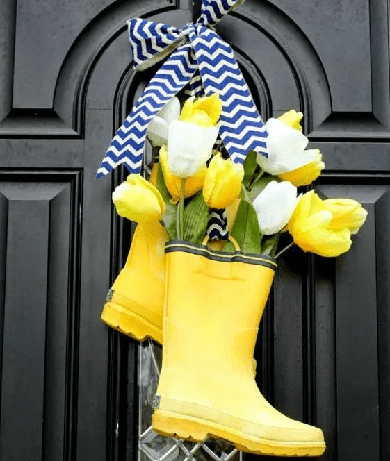 bright yellow rain boot decor with yellow and white tulips and a chevron bow is a very cool and bold idea