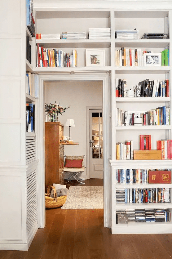 shelves on both sides of the doorway and over it are great for storage and display, here they are used as bookshelves