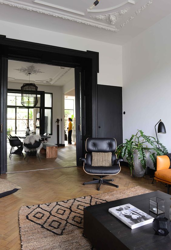 a beautiful space with large black doors and black touches in each room that echo with them and make the space more cohesive