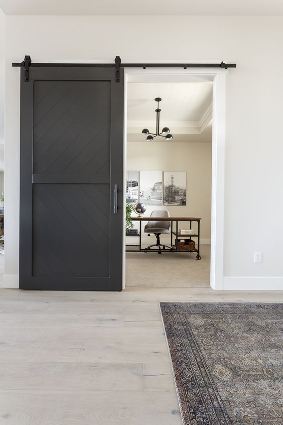 a black barn door is a nice addition to a farmhouse space, it adds drama and interest to the space