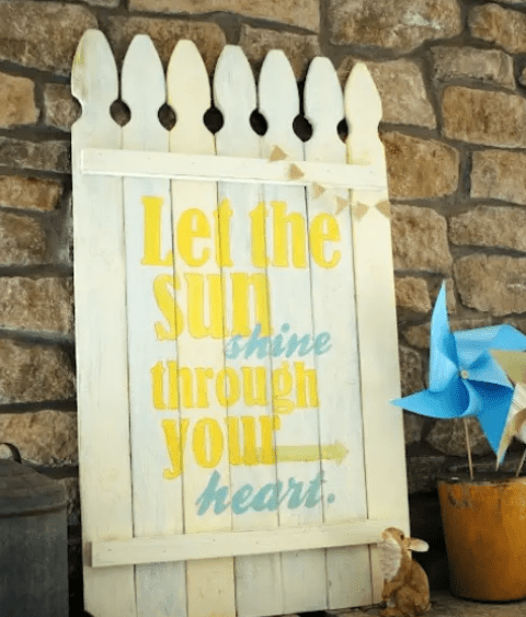 A bold rustic sprign sign in white with blue and yellow letters feels and looks very spring like