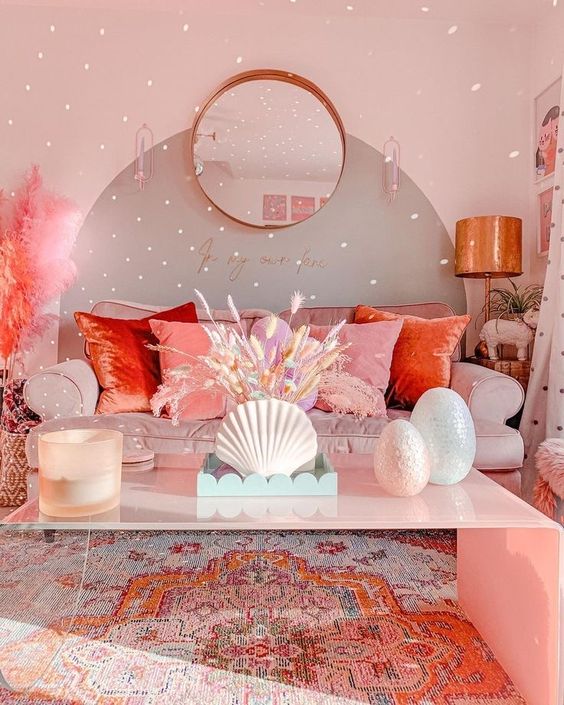 a bright dopamine living room with a blush sofa, colorful pillows, a pink table and colorful wheat plus pink pampas grass