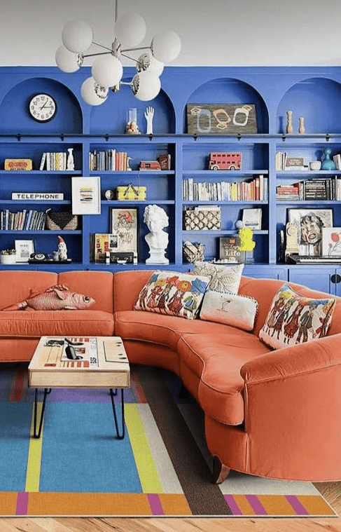a bold maximalist living room with bookcases