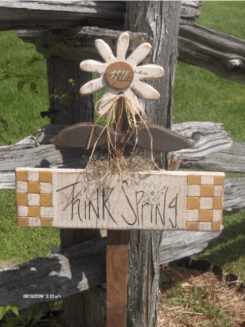 a bright wooden sign with check and letters hanging on a flower is a lovely idea for a rustic space