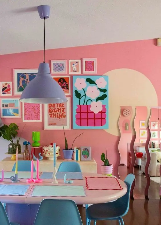 a colorful and dopamine decor dining room with pink walls, a super bright gallery wall, bleu chairs and a periwinkle lamp and cool decor