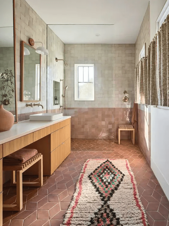 a creative boho bathroom with terracotta and Zellige tile, a large vanity, a shower space and a large boho rug