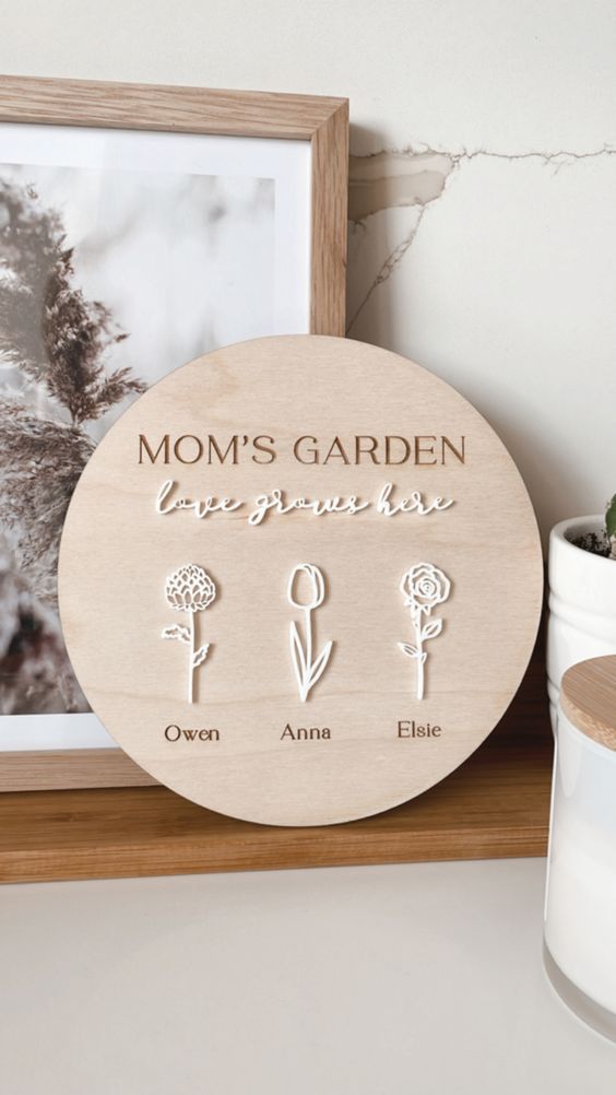 a creative family spring sign of a wooden plaque, calligraphy and blooms with children’s names is love