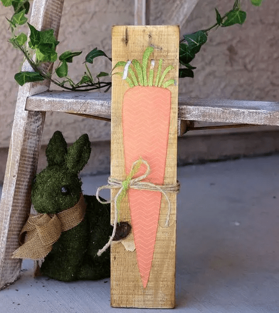 a cute and simple carrot pallet sign with dimension and a twine bow is a lovely idea for spring