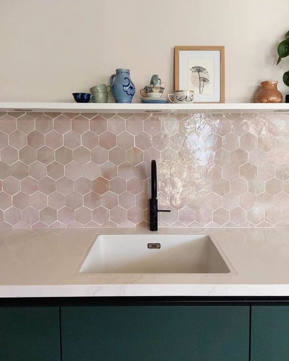 a dark green kitchen with white countertops and a pink hexagon Zellige tile backsplash and an open shelf is amazing