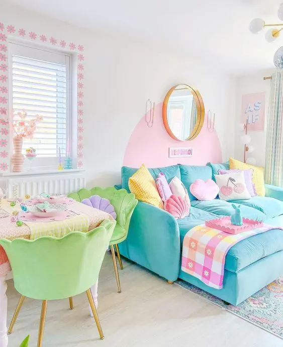 a dopamine decor space with bright and pastel colors, a blue sofa, pastel pillows, bright green chairs