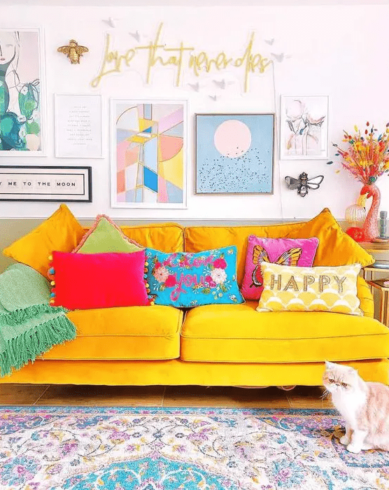 a cute living room with a yellow sofa