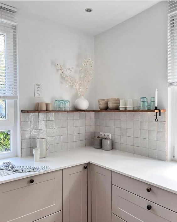 a dove grey kitchen with white countertops, a neutral square Zellige tile backsplash and open shelves
