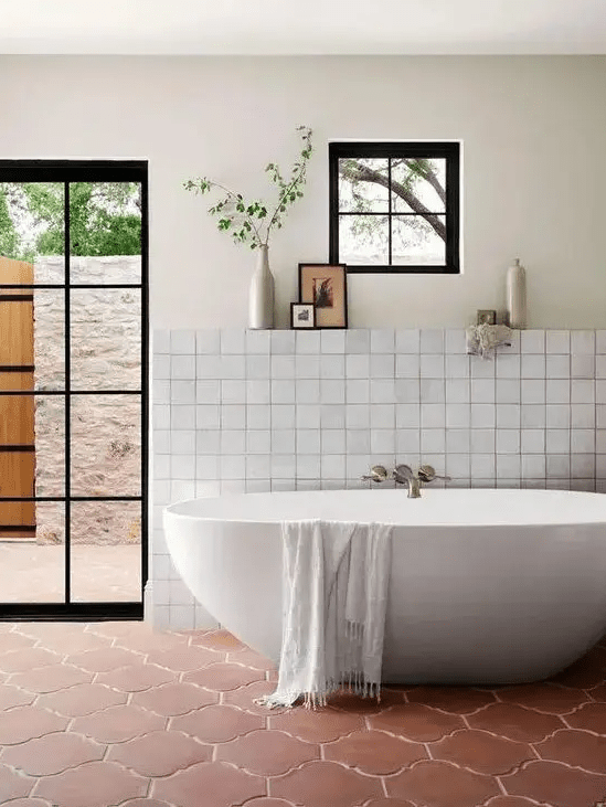 a neutral bathroom with a glass door leading outside