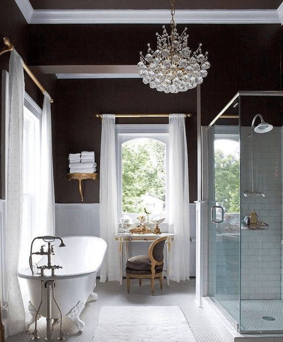 a gorgeous art deco bathroom with a statement crystal chandelier that adds a refined and elegant feel to the space