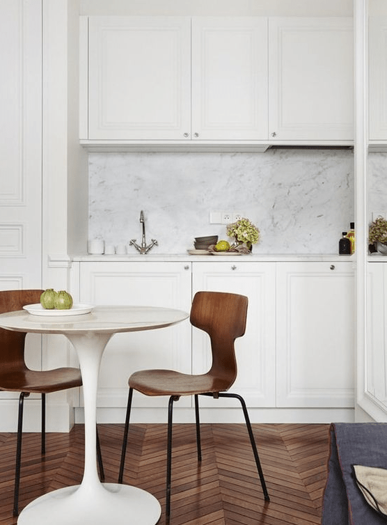 a stylish kitchen with a quartz backsplash