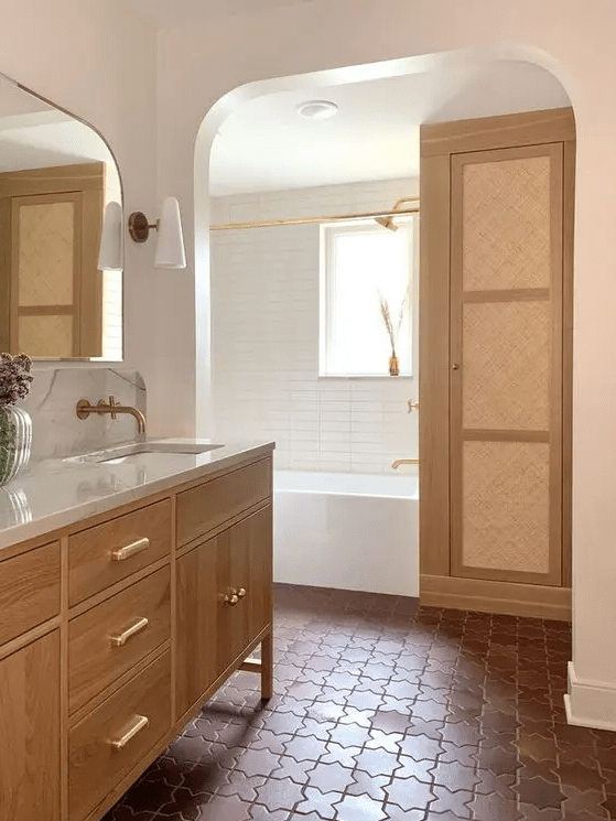 a modern bathroom clad with white skinny and terracotta tiles, a bathing space with a wardrobe, a stained vanity and a mirror