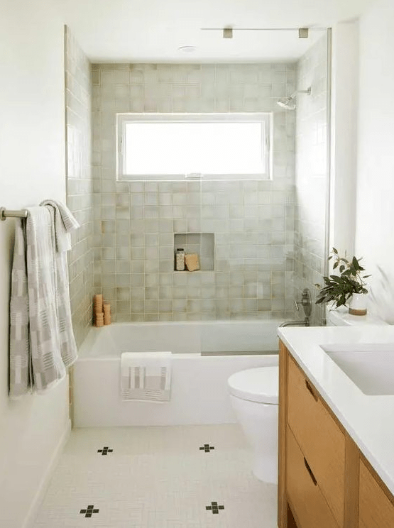 a modern bathroom with neutral walls and green terrazzo tiles, a stained vanity, a neutral tiled floor and white appliances